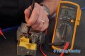 How do you test a Honeywell gas valve with a multimeter?